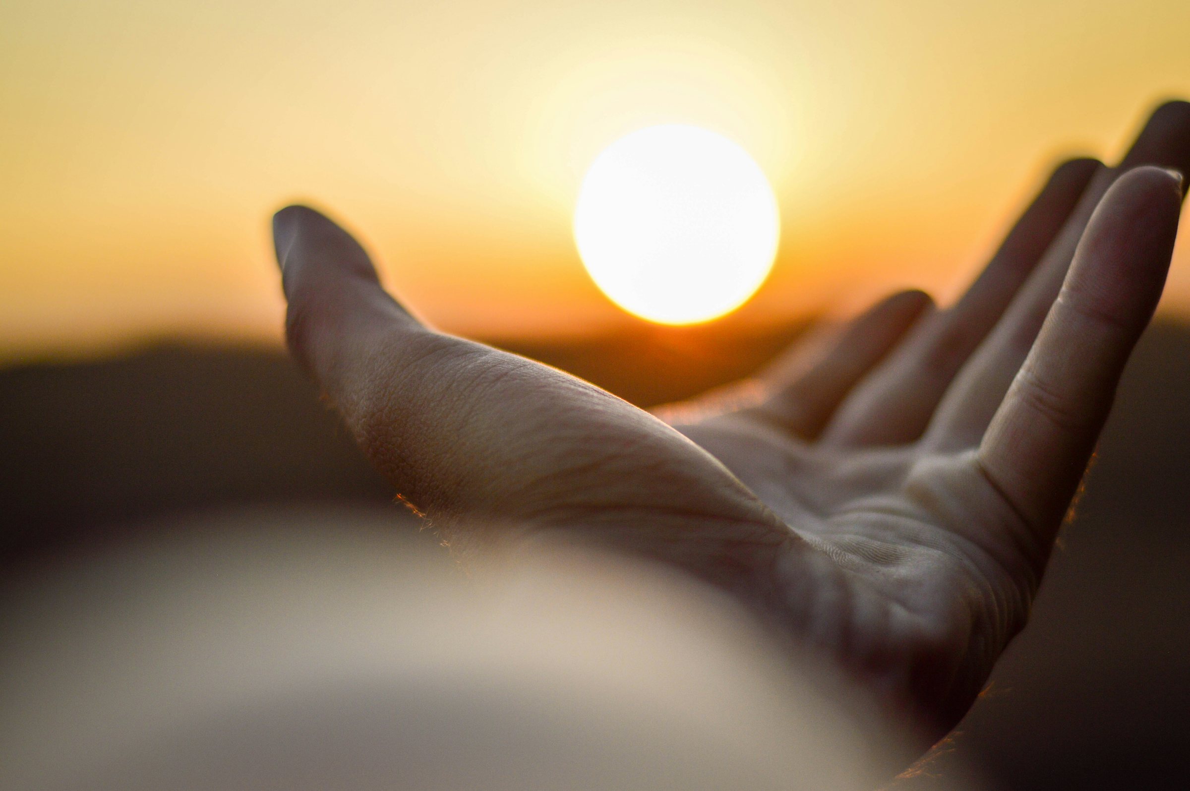 A hand open to the light, symbolizing hope in recovery
